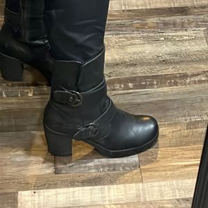 Black leather calf high boot. With adorable belt detail.